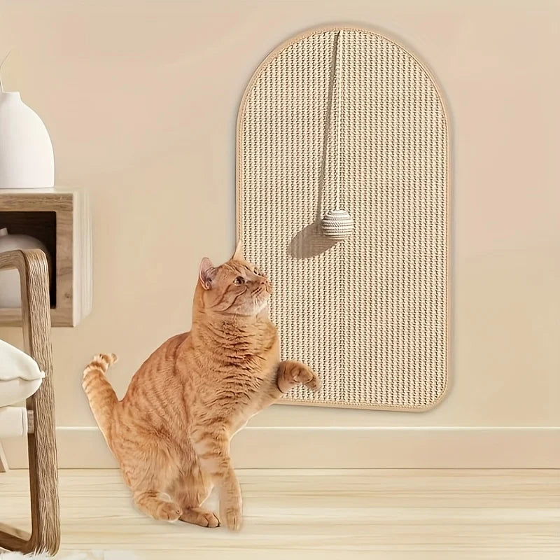 Cat playing with the ball on the sisal scratching post